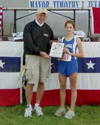 Image of Lissa DiPaola (Westhill) receives the Ted Chwazik Award for the fastest junior high female runner from Mr. Ted Chwazik
